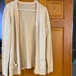 Cream cardigan with pink stitching and pockets